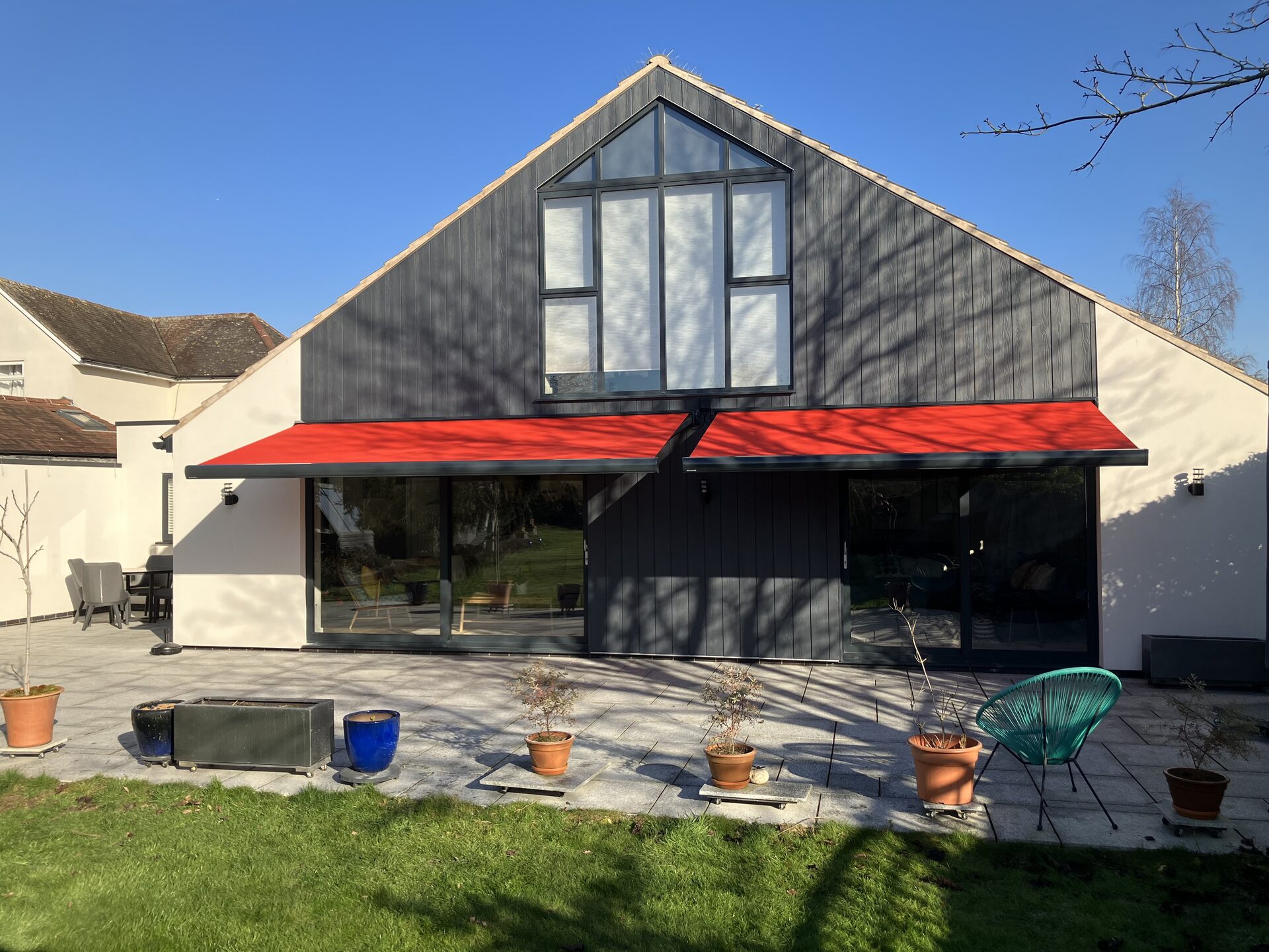 Electric retractable patio awning over a residential garden